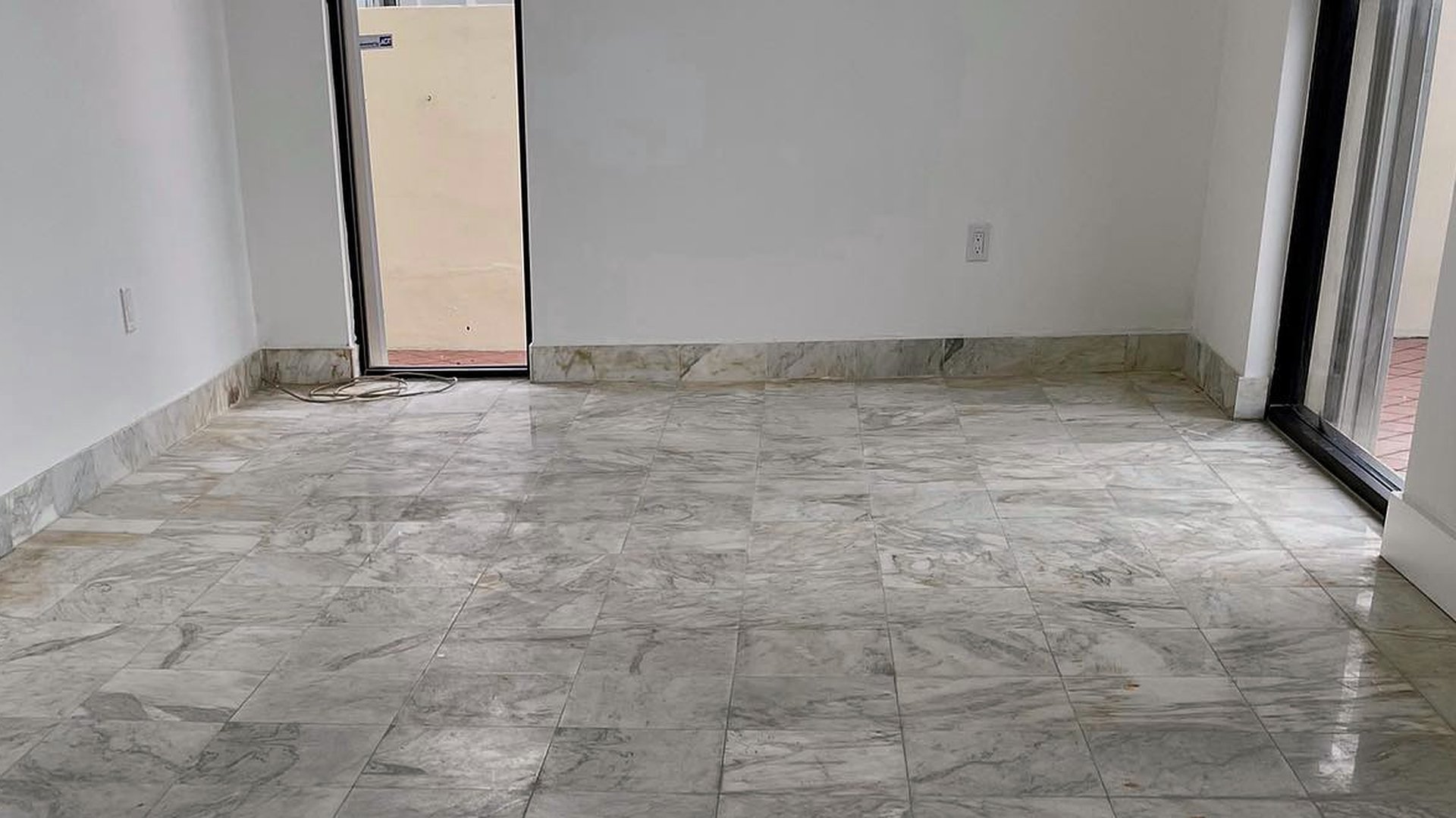 Dull marble floor in an empty room before restoration